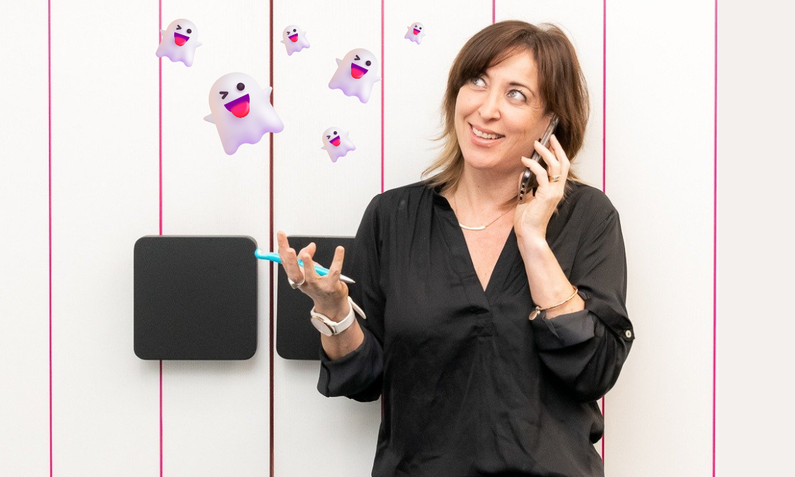 Vikki on the phone looking up to floating ghosts