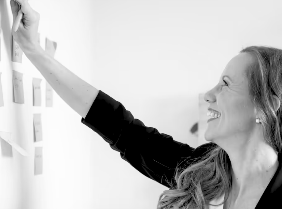 Shannyn putting sticky notes on the board