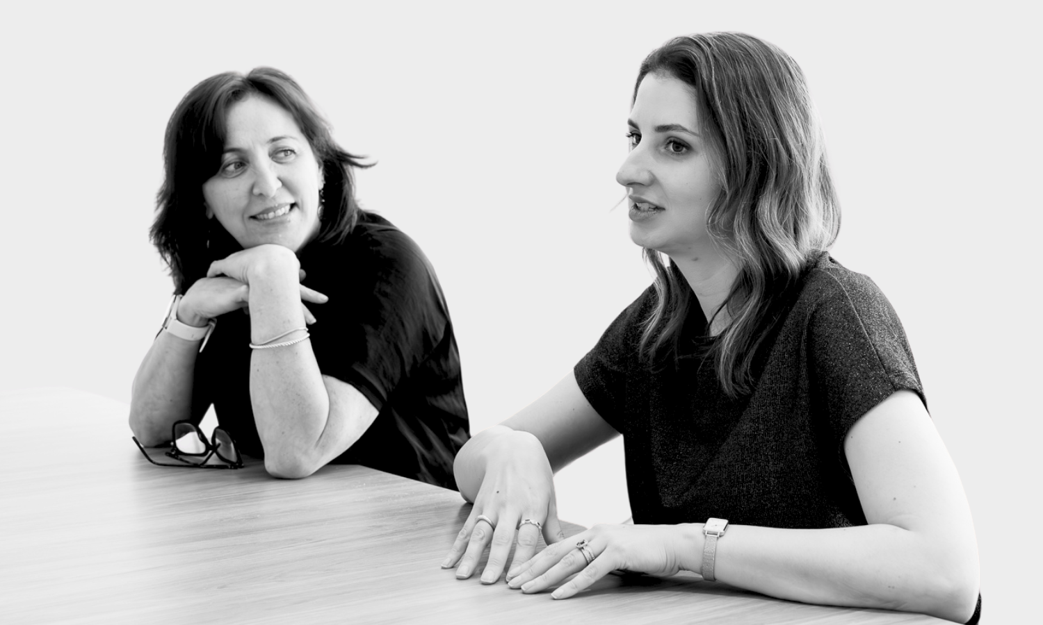 Vikki and Veronica talking in a meeting room at work