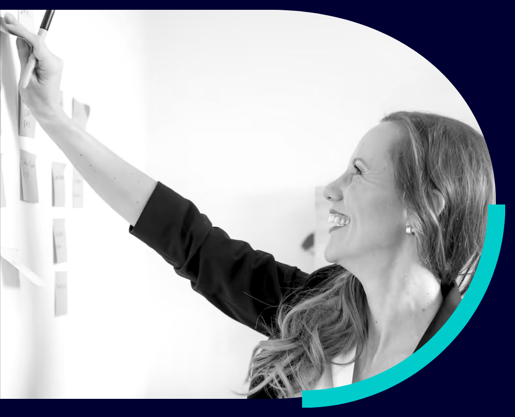 Shannyn putting sticky notes on a whiteboard