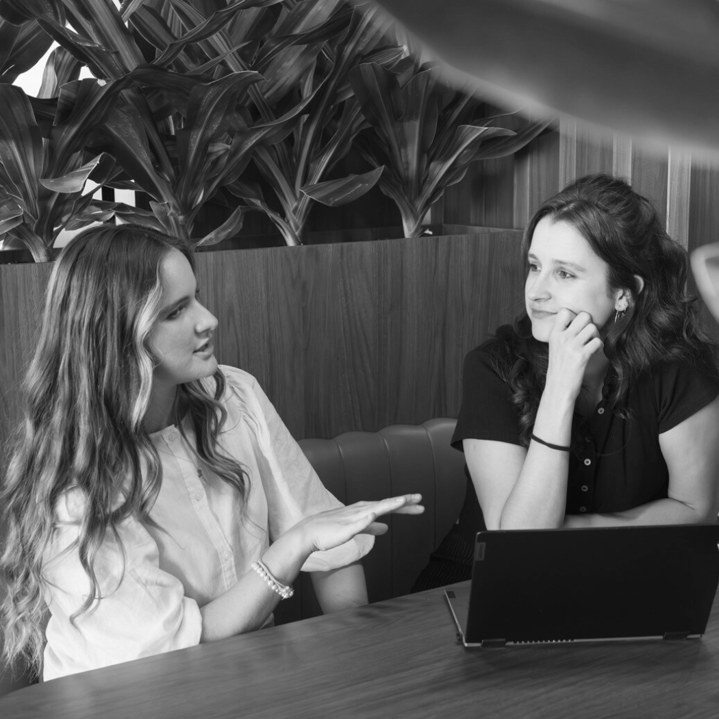 Team members discussing a topic while sitting in a booth