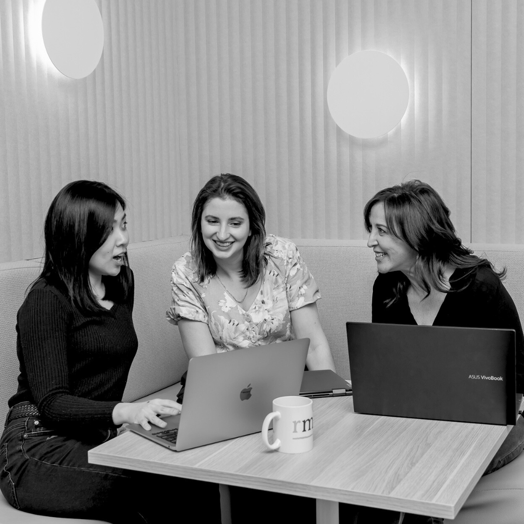 Team collaborating on their laptops