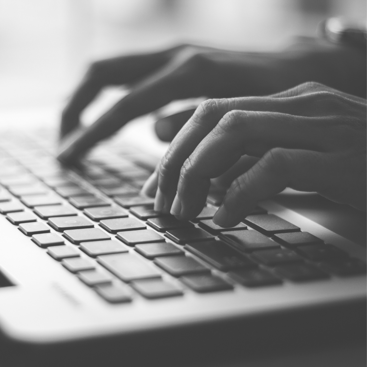 Typing on a laptop - black and white